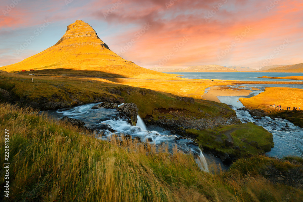 Obraz premium Mt. Kirkjufell and Kirkjufellsfoss waterfall at Sunset, Iceland. The fall also known as Church Mountain Falls located at Kirkjufell mountain on the west side of Iceland.