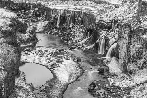 Hrauneyjarfoss waterfalls, onset of winter, black and white photo, Sudurland, Iceland