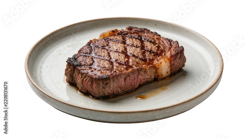 Juicy grilled ribeye steak with grill marks, served on a ceramic plate isolated on transparent background