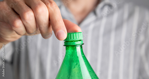 Man opening bottle of water. Close Up view