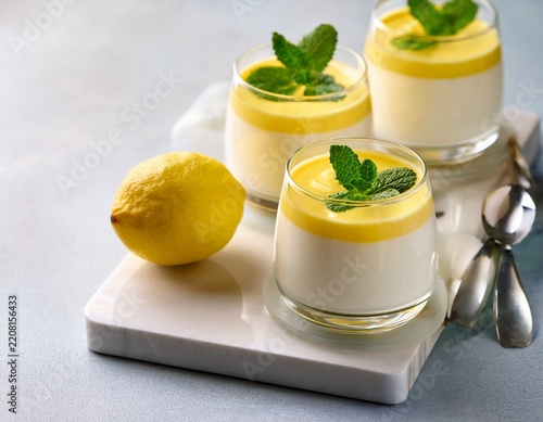 creamy dairy yoghurt dessert sweet mousse with mascarpone cream cheese mint and lemon juice in glasses on marble tray