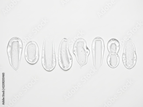 Set of clear transparent cosmetic gel smears and serum swatches in a row on white background, skincare texture