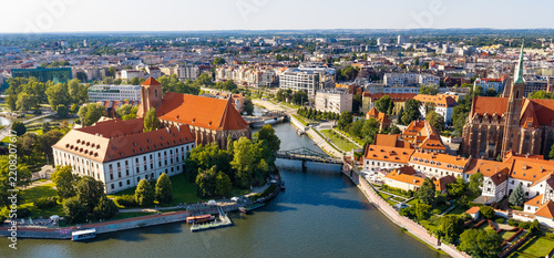 Panoramic aerial view of Holy Cross and St. Bartholomew Collegiate Church on Ostrow Tumski Cathedral Island and Sand Island at Odra River in historic old town district of Wroclaw in Poland