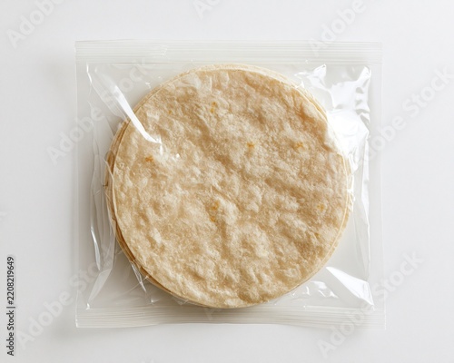 Plain, round tortillas in clear plastic packaging.