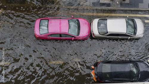 Aerial view of cars parked on a flooded city street after heavy rainfall during a storm event