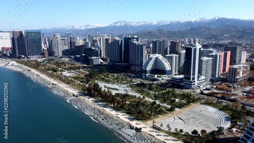 Aerial view of Batumi waterfront skyline and snowcapped mountains