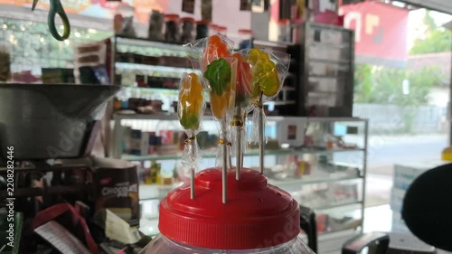 Hand Arranging Colorful Candy at a Market Stall