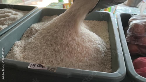 Scooping Loose Rice from a Bulk Market Container