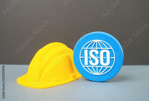 Construction helmet and ISO symbol. Standards in the construction industry. Quality control, certification, workplace safety and international building requirements.