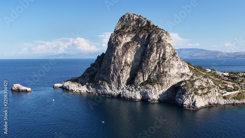 Aerial drone view of Cape Zafferano in Sicily, Italy, showing rugged rocky coastline of the Tyrrhenian Sea with crystal clear turquoise water, small islands and beautiful Mediterranean landscape.