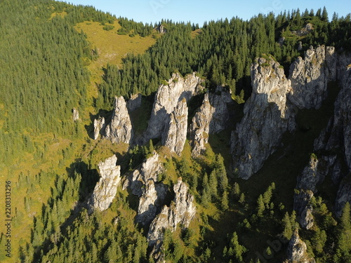 Aerial view of Mnichy Chochołowskie rock towers and Skorusi Źleb gully illuminated by sunrise in summer, Tatra Mountains