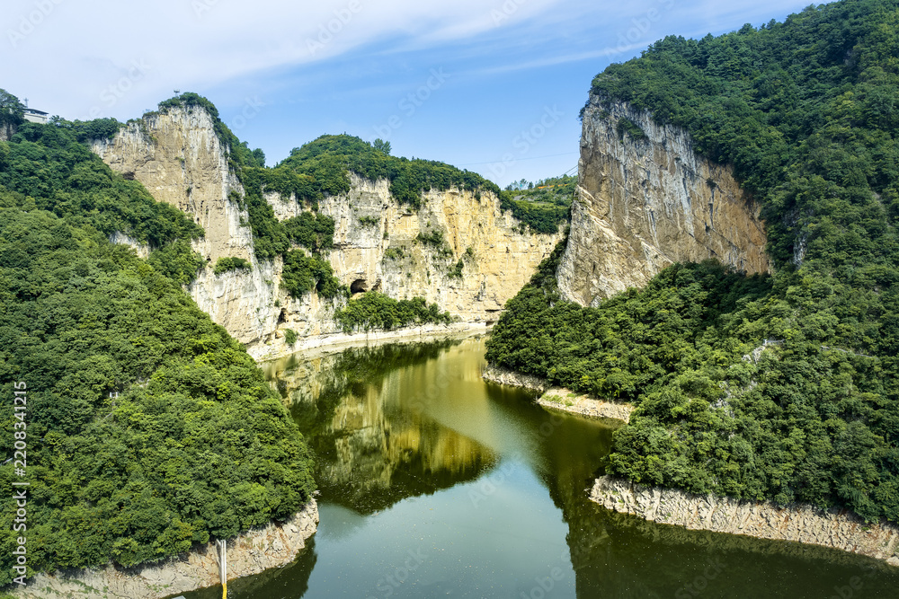 Fototapeta premium Scenic canyon river view with lush green cliffs in Bijie, Guizhou, China
