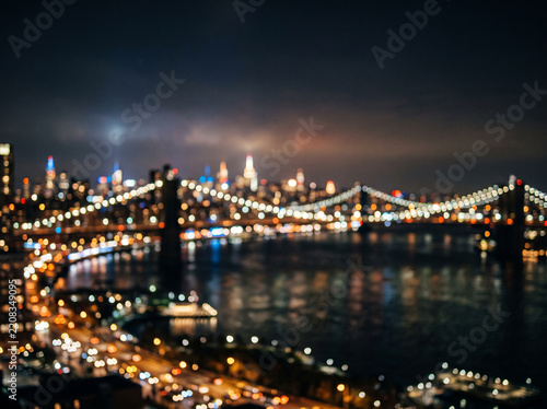 Bokeh night view of a suspension bridge and illuminated city skyline