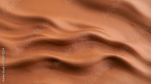 Matte Liquid Clay Surface with Flowing Waves, Abstract Texture Background, Earthy Tones, Creative Design Element, Commercial Use.