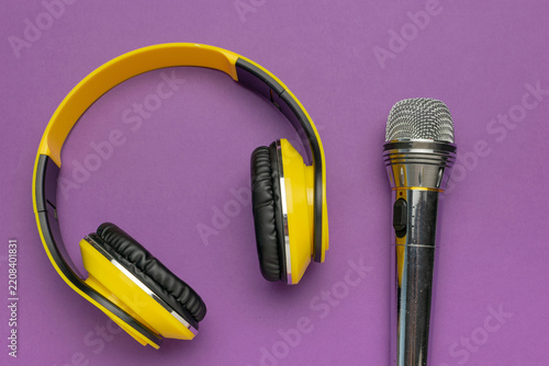Colorful Audio Equipment: Yellow Headphones and Silver Microphone on Purple Background