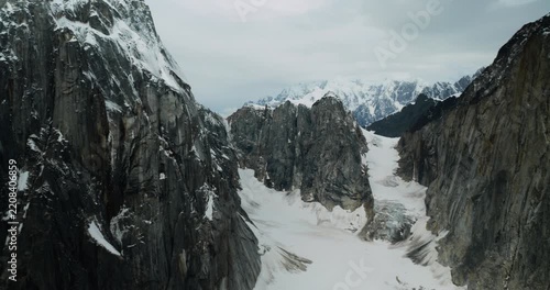 Aerial view of the rugged snow-covered peaks and glacial valleys of Mount McKinley, captured from a small plane in Denali Borough, Alaska, United States.
