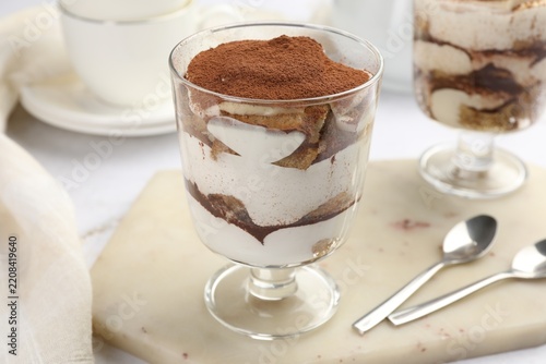Obraz na plátně Tasty tiramisu in dessert coupes served on white table, closeup