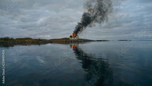 Burning Scandinavian House on Baltic Sea Coast in Autumn