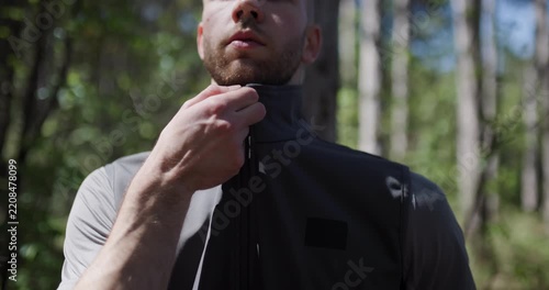 Outdoor adventure tips while wearing a practical zippered vest in a lush forest environment on a sunny day