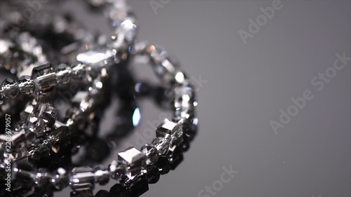 Crystals bracelet or necklace border jewels, gems, diamonds over black background, beautiful gems, rhinestones, brilliants sparkling with colorful caustics, rainbow lights. Moissanite. Zirconia 