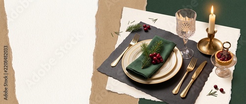 Elegant holiday table setting with candle, plate, green napkin and festive accents, intimate Christmas or New Year dinner atmosphere for seasonal dining and celebration