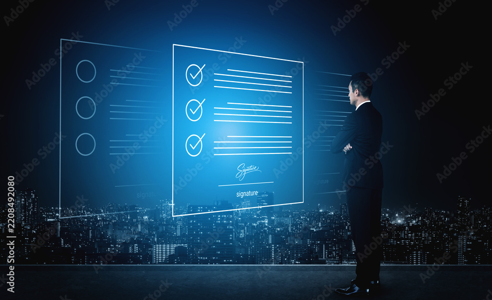 Obraz premium A business professional stands in front of holographic digital documents and a checklist, reflecting on modern technology and urban success at night in a futuristic setting. Cyphers