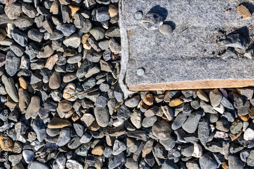 Quebec, Canada, 22 August 2026 : Geotextile fabric membrane secured next to gravel aggregate layer on outdoor construction site