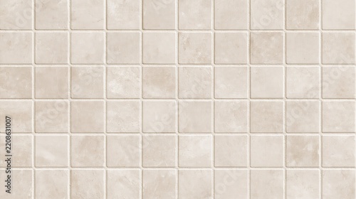 Seamless texture of light beige square ceramic tiles with subtle stone pattern and thin grout lines for interior wall or floor surface finish