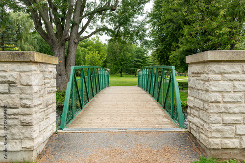 Scenic Green Footbridge Over a Creek in a Park