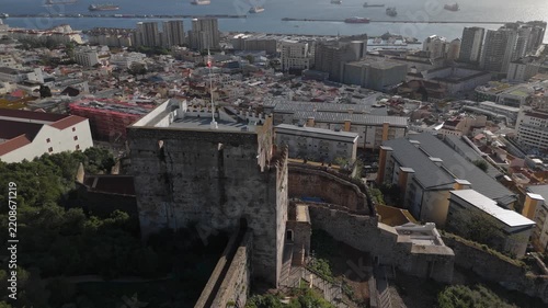 Gibraltar, Gibraltar - 17 July 2025: Aerial view of the historic Moorish Castle with its stone tower and battlements overlooking the surrounding urban landscape.