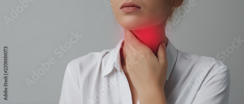Woman experiencing throat discomfort.