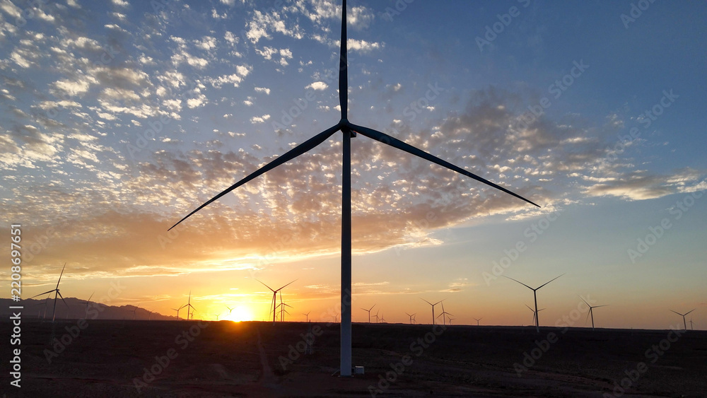 Obraz premium silhouette of wind turbine against sunset sky