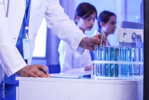Medical research and clinical trial, scientist working with test tubes and bl...