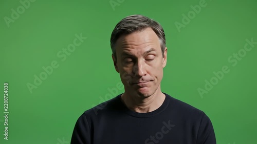 Man looking up thoughtfully on a green screen background