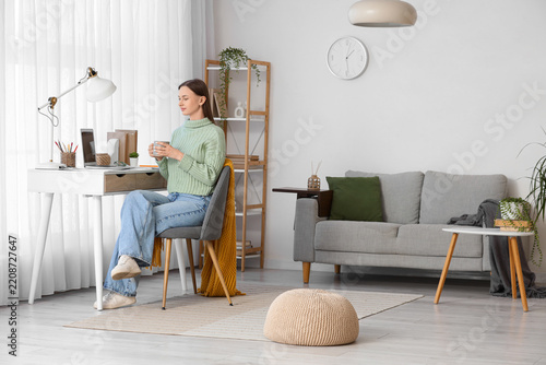 Remote work and work-life balance, young woman working on laptop at home offi...