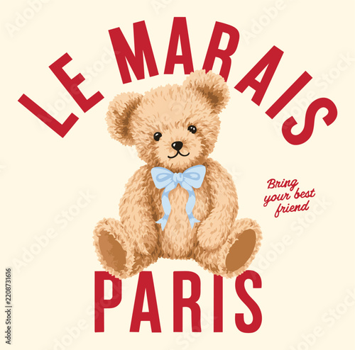 Small Teddy bear wearing blue bow on neck isolated cream background 
