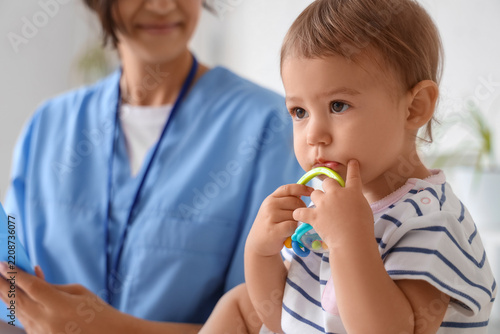 Pediatric healthcare and child wellness, toddler patient with teething toy du...