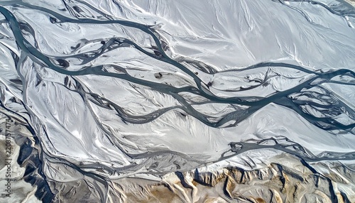 Abstract icy marble texture with flowing silver and white waves.