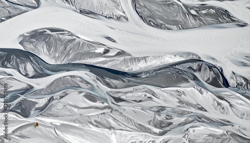 Abstract icy marble texture with flowing silver and white waves.