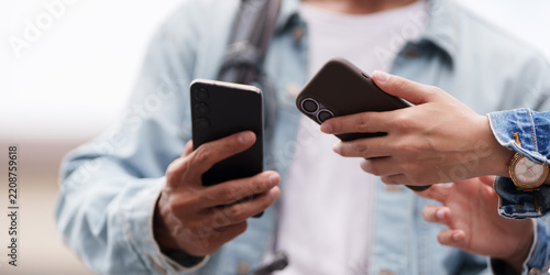 Hands holding smartphones for digital communication and mobile app usage