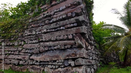 Closeup pan down tall stone walls of Nan Madol buildings in Madolenihmw district, Pohnpei, Federated States of Micronesia