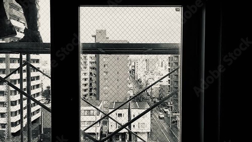 Worker’s feet on scaffolding seen through a window