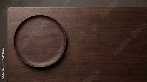 Minimalist dark walnut wood tabletop with a carved circular plate indentation for modern interior design