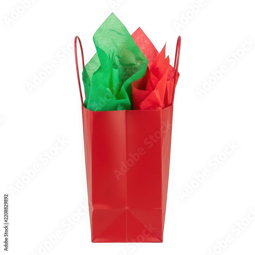 Red gift bag filled with colorful crinkle paper and handles transparent background