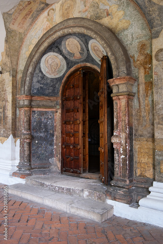 Old wooden door Church of Elijah with paintings at a historical building