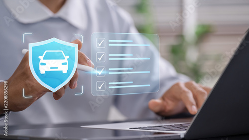 Vehicle insurance verification and policy management with professional reviewing digital car coverage checklist, protection requirements and insurance policy using laptop