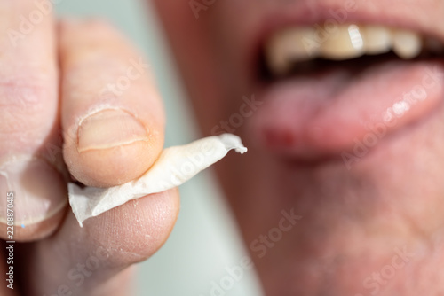 Stockholm, Sweden A man places a smokeless and tobacco-free nicotine pouch or snus on his tongue.