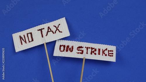 Protest placard with white lettering on a blue background. Studio shot of the handwritten text.