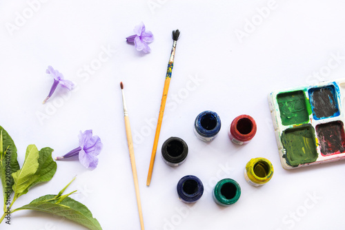 paints, brush and palette drawing of lifestyle arrangement flat lay style on background white