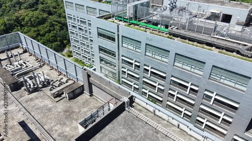 Rooftop ventilation pipes and cooling system on a modern data center building.